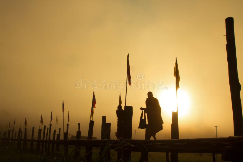 Silhouette Monk walking sunset