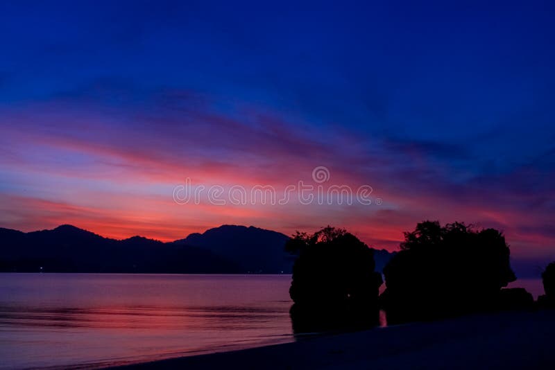 Silhouette of mountain cliff at violet sunset on sea beach resort in Thailand, Krabi, Railey and Tonsai stock photo Silhouette of mountain cliff at violet sunset on sea beach resort in Thailand, Krabi, Railey and Tonsai stock photo