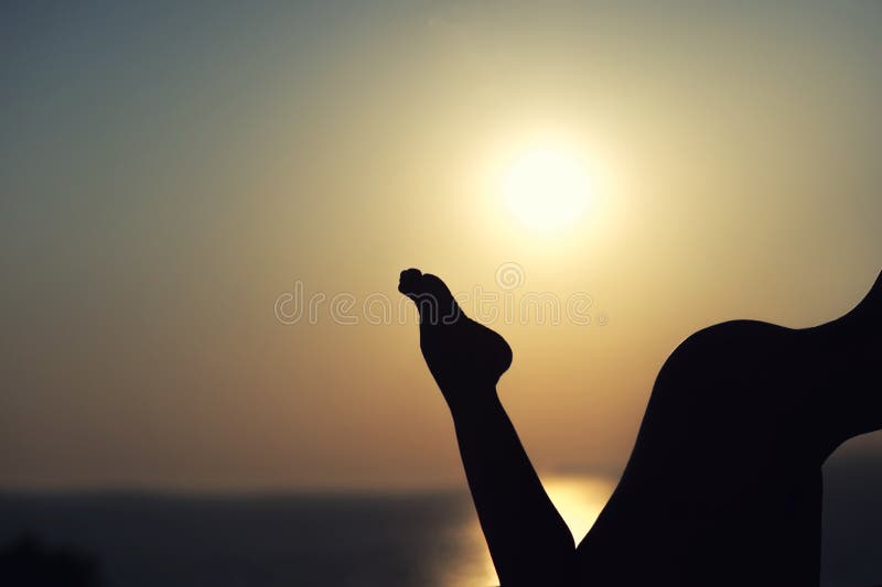 Silhouette of nude girl on sunset background