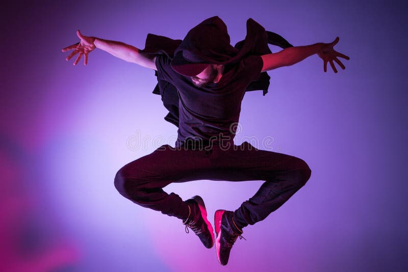The silhouette of one hip hop male break dancer dancing on colorful background stock images The silhouette of one hip hop male break dancer dancing on colorful background stock images