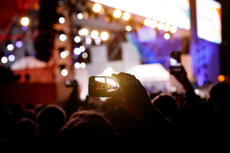 Silhouette of people holding their smart phones and photographing concert royalty free stock photo Silhouette of people holding their smart phones and photographing concert royalty free stock photo