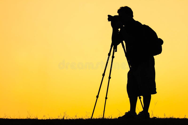 Silhouette of photographer shooting photo for a sunrise