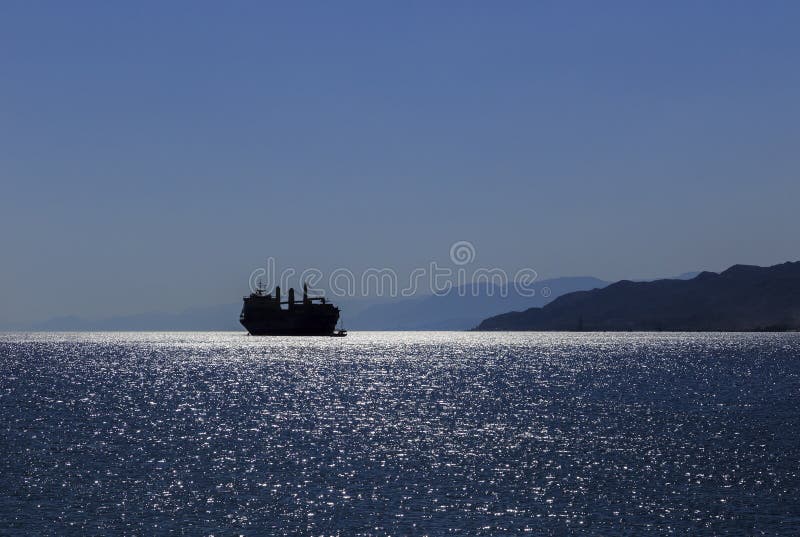 Silhouette of a ship in the Gulf of Aqaba of the Red Sea stock photos