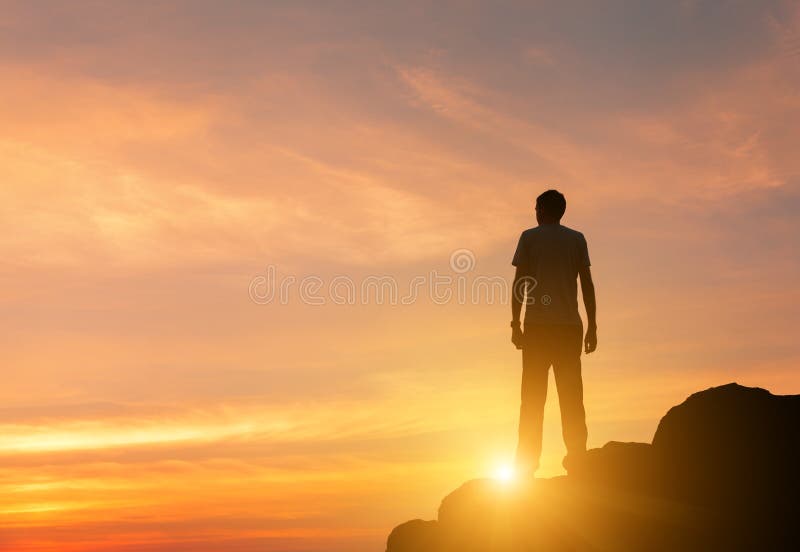 Silhouette of a standing man at colorful sunset in summer