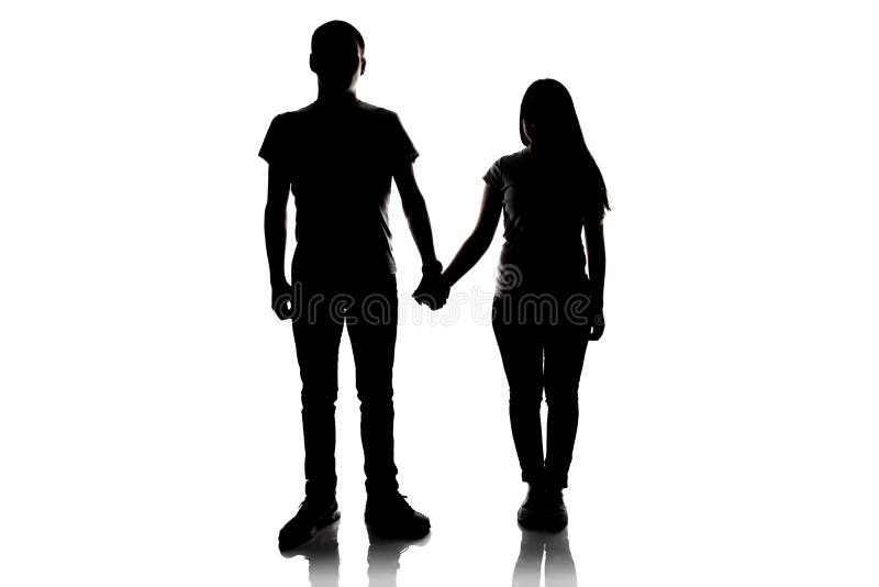 Silhouette of teenagers holding hands royalty free stock photography