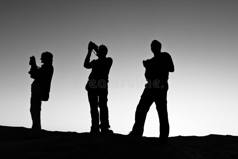 Silhouette of Three People Photographing stock photos