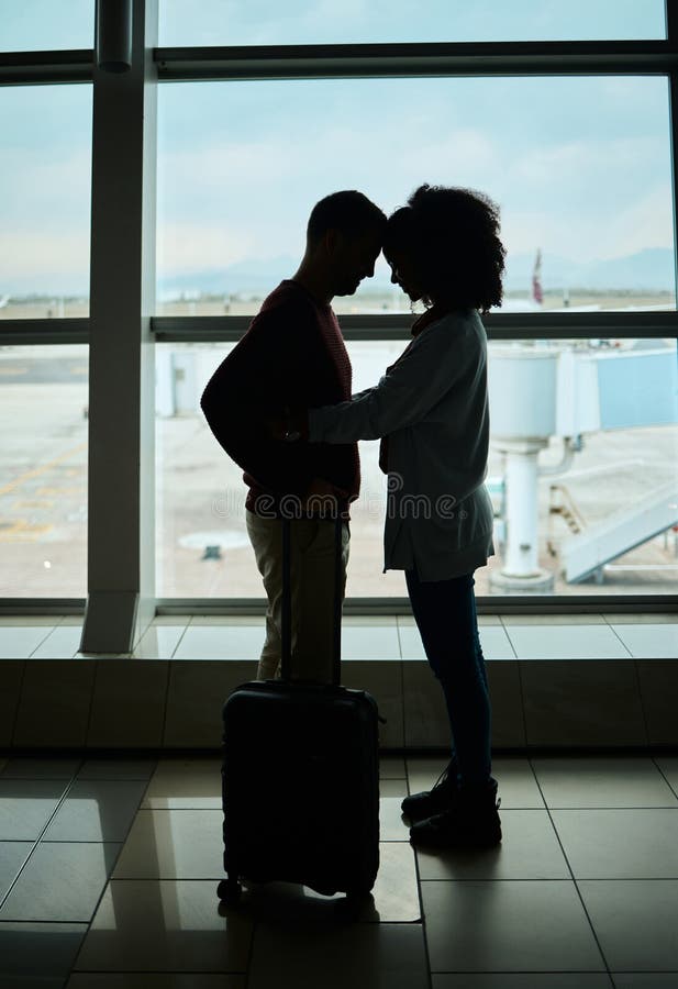 Silhouette, travel and love with couple in airport and hug for departure, flight and say goodbye. Shadow, holiday and