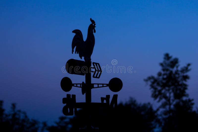 Silhouette wheather vane at dawn