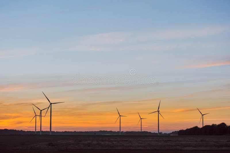 Silhouette of wind turbine on sunset