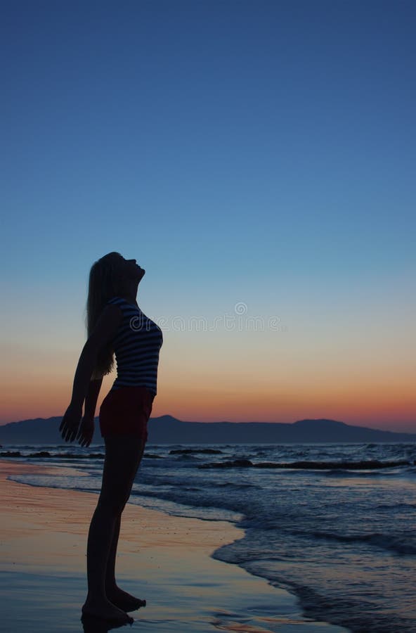 Silhouette of a woman on a beach