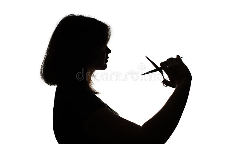 Silhouette of woman with hairdressing scissors in hands on white isolated background