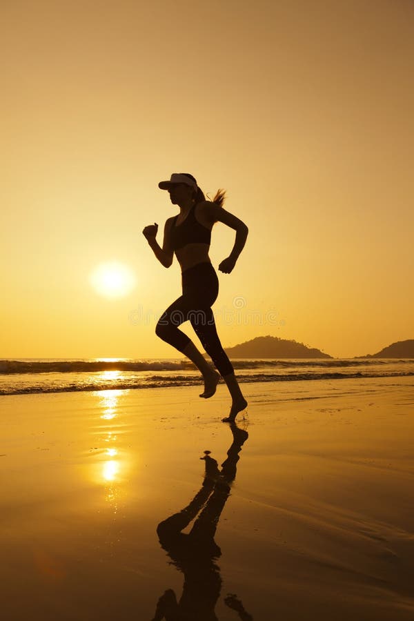 Silhouette woman jogging on the beach