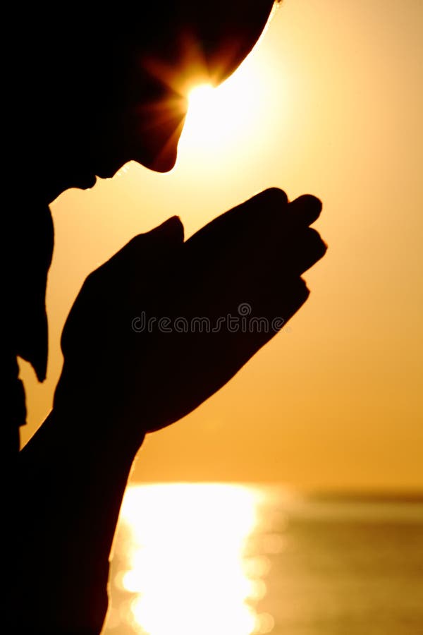 Silhouette of woman prays