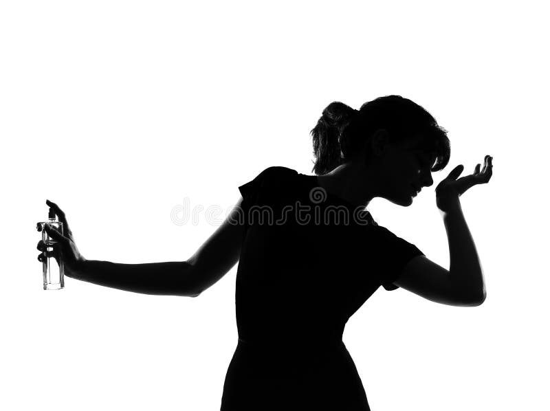 Silhouette woman smelling perfume stock photo