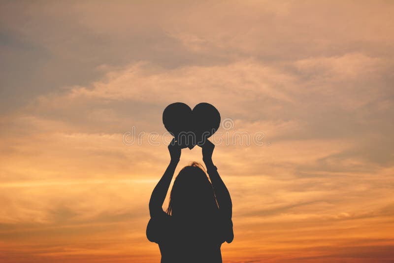 Silhouette of women hands holding heart shape royalty free stock images