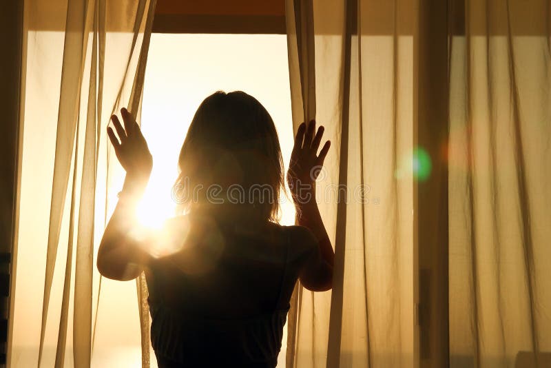 Silhouette of a women near the window