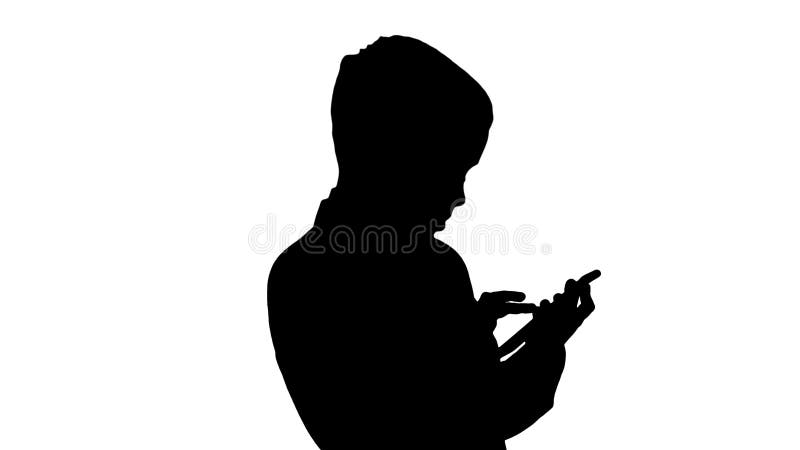 Silhouette Young boy in elegance suit playing with mobile phone.