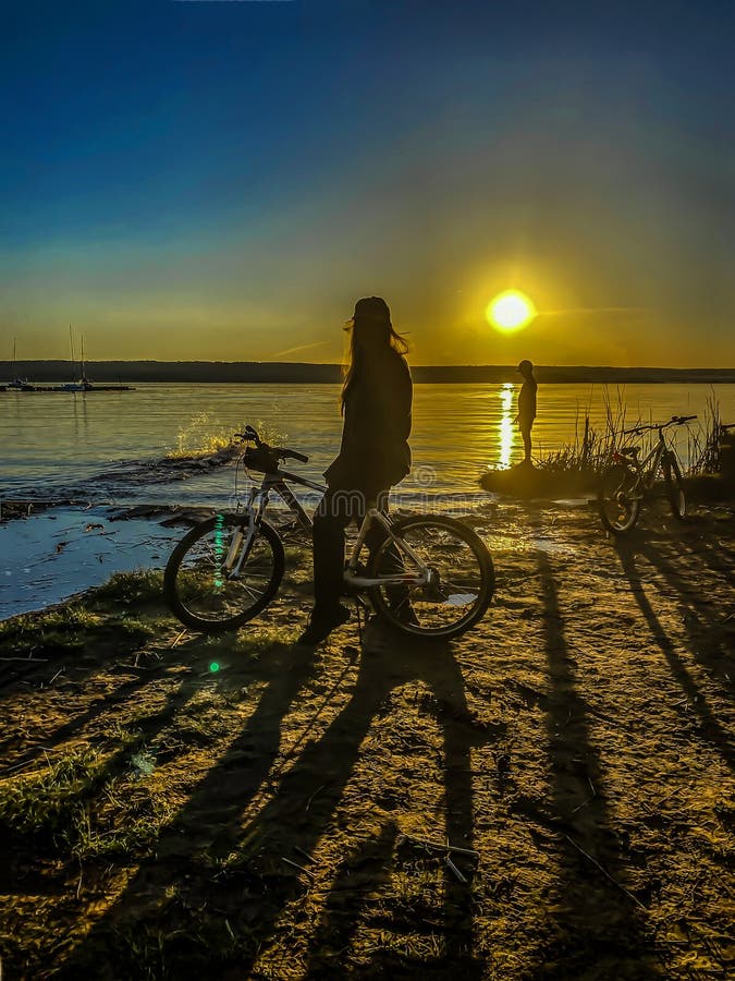 Silhouette of a Young Girl at Sunset on the Background of the River with  Bike, Summer and Sports Stock Photo - Image of effect, vacation: 220973920