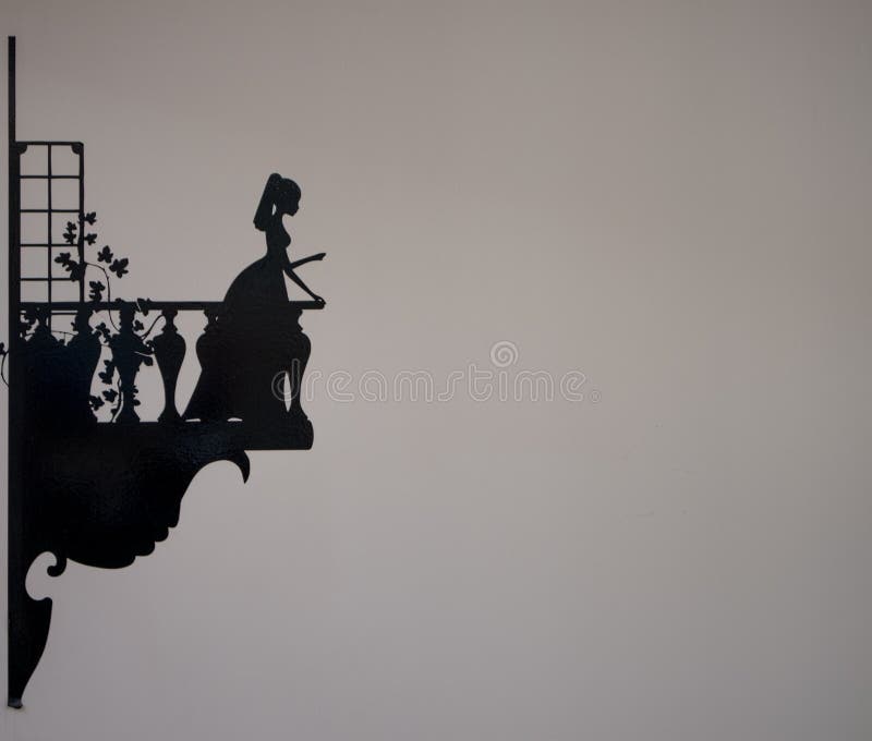 Silhouette of young maiden leaning out of balcony