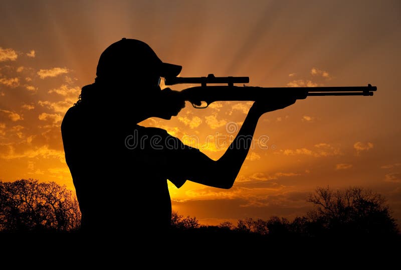 Silhouette of a young man with ponytail shooting