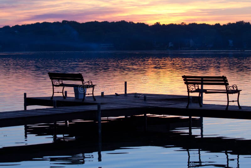 Silhouetted Benches on Wooden Pier at Sunset royalty free stock images Silhouetted Benches on Wooden Pier at Sunset royalty free stock images