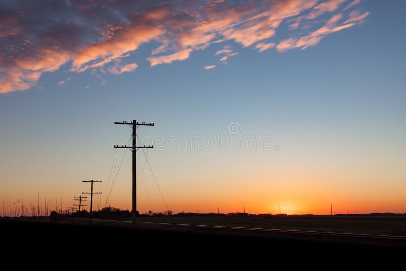 Silhouetted Telegraph Lines at Sunrise. Silhouetted telephone lines at sunrise outside Winnipeg Manitoba stock photos Silhouetted Telegraph Lines at Sunrise. Silhouetted telephone lines at sunrise outside Winnipeg Manitoba stock photos