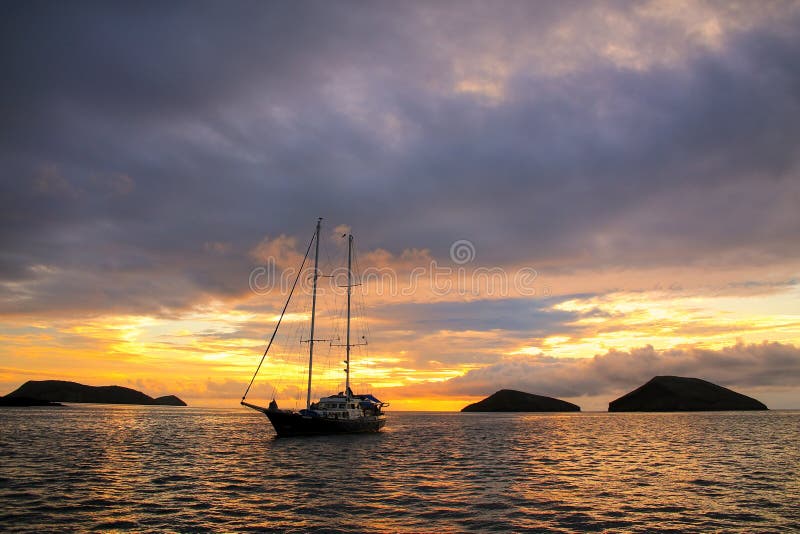 Silhouetted tourist sailboat at sunrise anchored near Chinese Ha