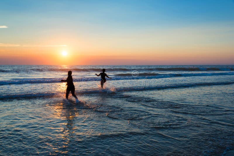 Silhouetten van mensen die van de zonsondergang op de Atlantische Oceaan genieten royalty-vrije stock foto Silhouetten van mensen die van de zonsondergang op de Atlantische Oceaan genieten royalty-vrije stock foto