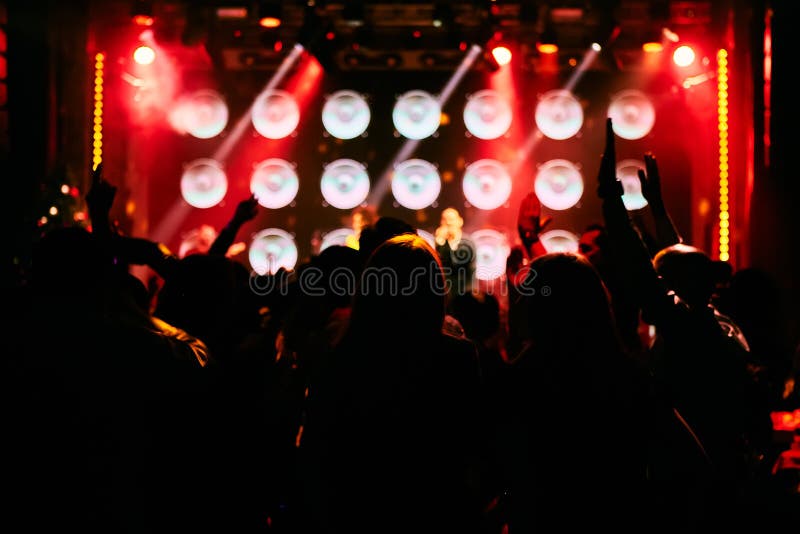 Silhouettes of Concert Crowd in Front of Bright Stage Lights with ...