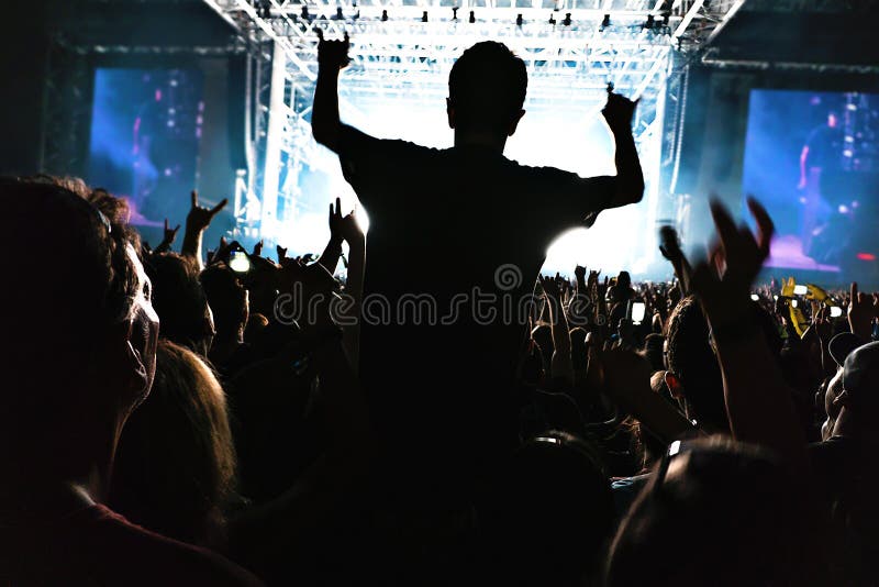 Silhouettes of Concert Crowd in Front of Bright Stage Lights. Editorial ...