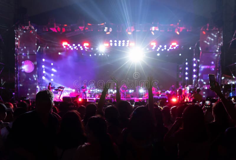 Silhouettes of crowd, group of people, cheering in live music concert in front of colorful stage lights royalty free stock photos Silhouettes of crowd, group of people, cheering in live music concert in front of colorful stage lights royalty free stock photos