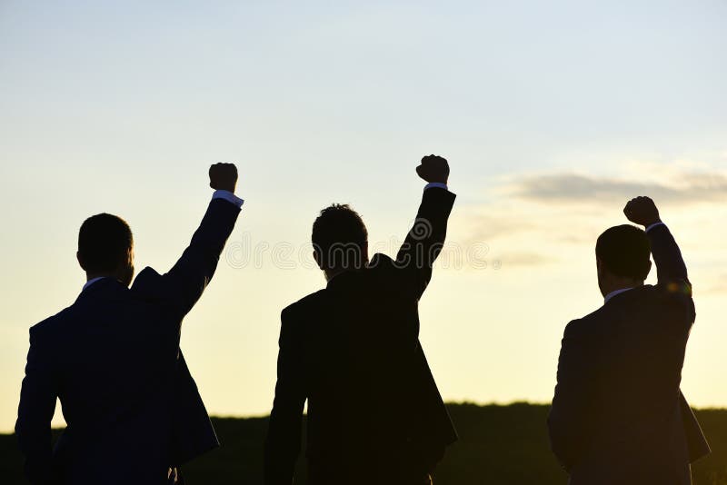 Silhouettes of men putting their fists up. Victory and success stock image Silhouettes of men putting their fists up. Victory and success stock image
