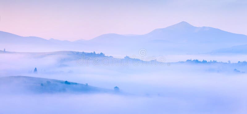 Silhouettes of the mountains in the morning mist