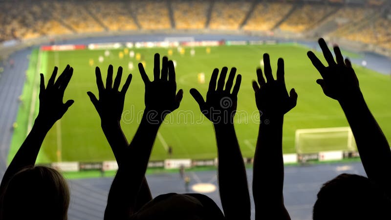 Silhouettes of soccer fans hands during match, crowded football stadium, sport royalty free stock photo Silhouettes of soccer fans hands during match, crowded football stadium, sport royalty free stock photo