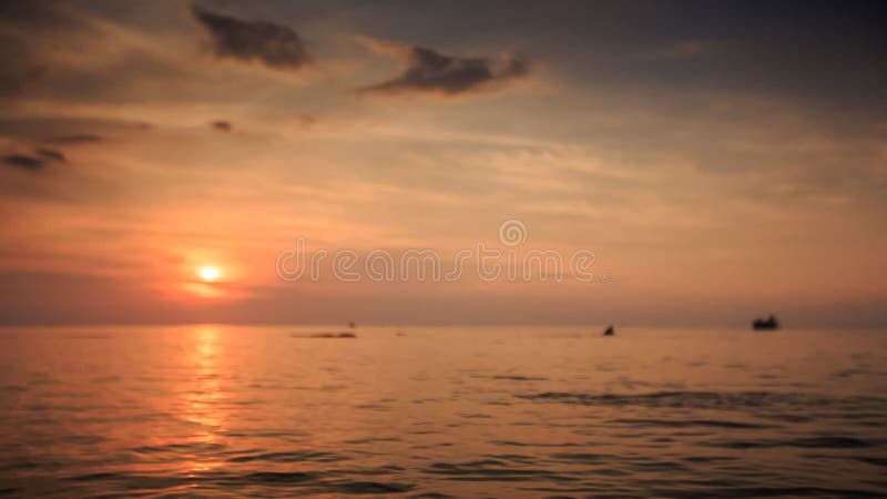 Silhouettes Swim Boat Drifts in Sea at Sunset Sun Reflection