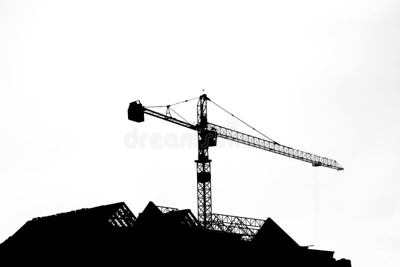 Silhouettes of tower crane at construction side stock images