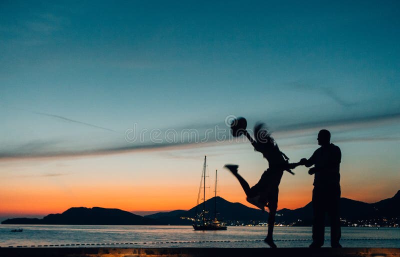 Silhouettiert liebevollen Paarküsten-Yachtsonnenuntergang stockfotografie Silhouettiert liebevollen Paarküsten-Yachtsonnenuntergang stockfotografie
