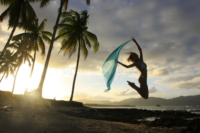 Silhouette of young woman jumping at Las Galeras beach, Samana peninsula, Dominican Republic. Silhouette of young woman jumping at Las Galeras beach, Samana peninsula, Dominican Republic