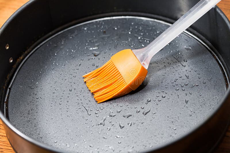Silicon Culinary Brush Kneading Oil on Baking Dish Stock Photo Image