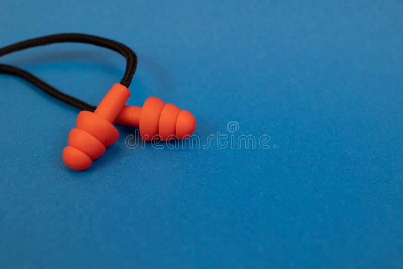 Silicone Ear Plugs for Human Ears on Blue Background Stock Photo