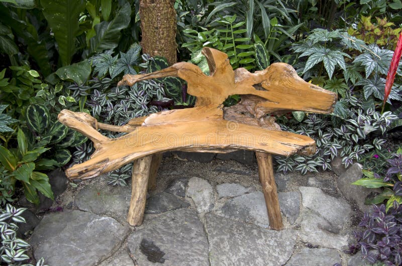 Chair with nice shape made of tree root in a garden. Chair with nice shape made of tree root in a garden.