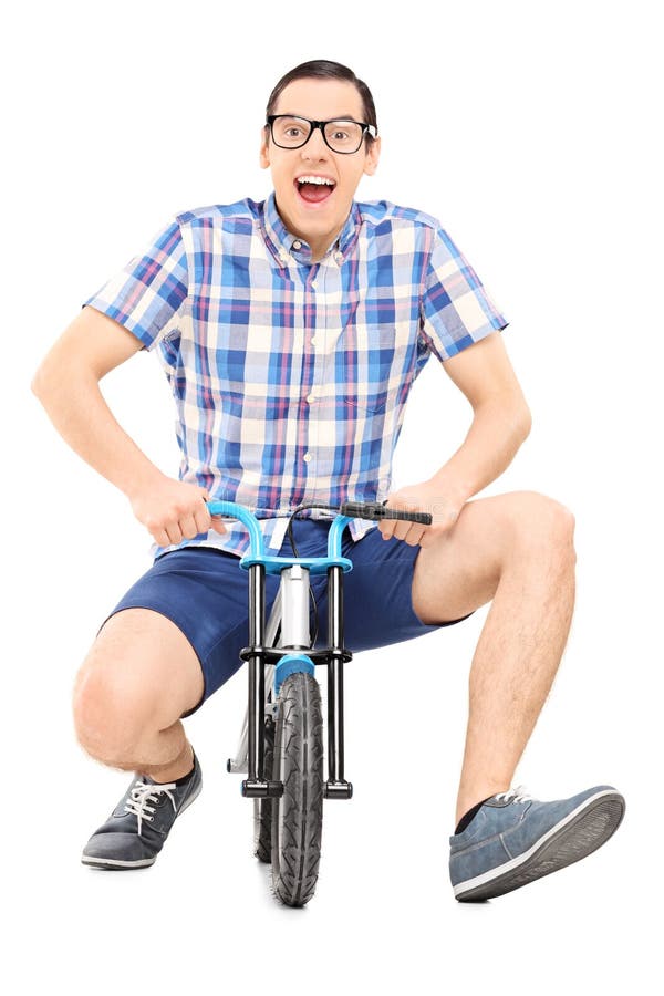 Silly Young Man Riding A Small Childish Bike Stock Photo - Silly Young Man RiDing Small ChilDish Bike IsolateD White BackgrounD 47618521