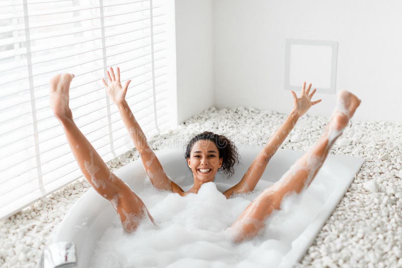 Woman Taking A Bubble Bath At Her Home