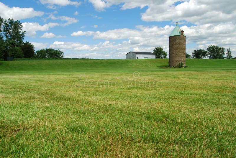 Silo and barn in a field