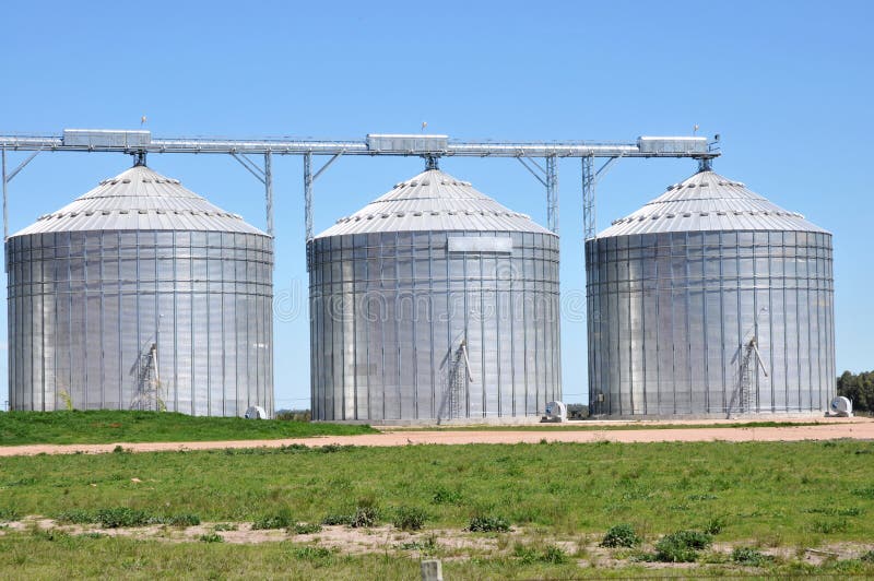 Three grain silos in rural area.