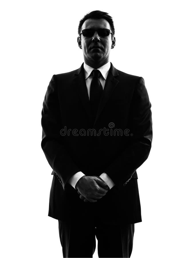 Silueta del hombre del agente del escolta de la seguridad del servicio secreto fotografía de archivo Silueta del hombre del agente del escolta de la seguridad del servicio secreto fotografía de archivo