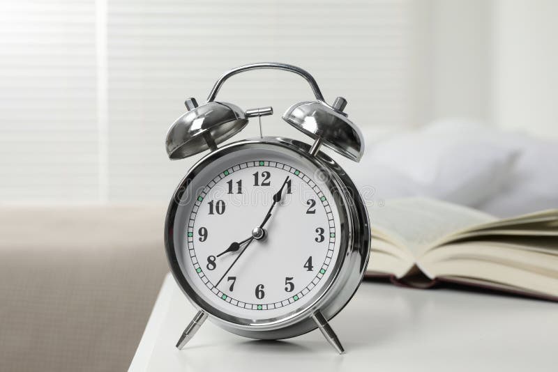 Silver Alarm Clock on White Nightstand in Bedroom Stock Photo Image
