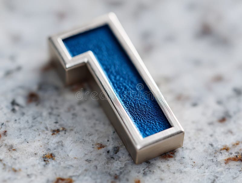 A silver and blue number one on a marble surface royalty free stock photography
