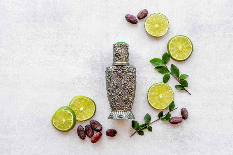 Silver Bottle of Arabian Oud Perfume with Ingredients Stock Image