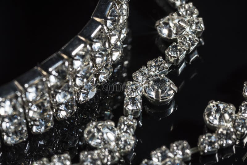 Silver bracelet and necklace with diamonds on black background close-up stock photos Silver bracelet and necklace with diamonds on black background close-up stock photos
